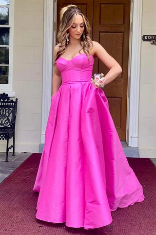 Vestido de noche largo de satén fucsia sin tirantes y con bolsillos PSK432