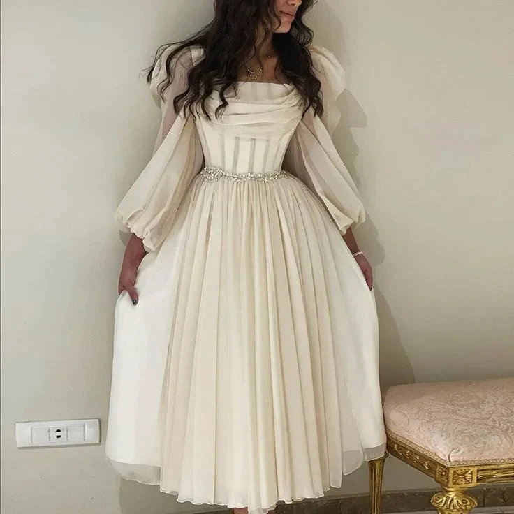 Woman in elegant ivory midi dress with sheer long sleeves from ZAPDRESS