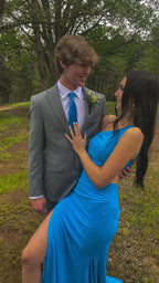 Couple outdoors in formalwear, woman in blue dress from ZAPDRESS, man in grey suit