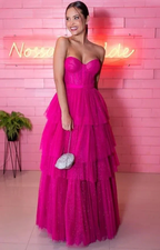 Woman in sparkly hot pink strapless tiered gown holding silver clutch, ZAPDRESS style