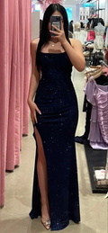 Woman in a sparkly navy blue evening gown with thigh-high slit at ZAPDRESS boutique