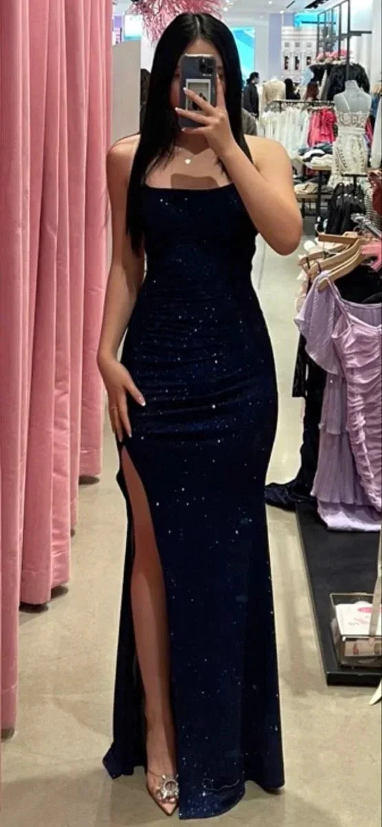 Woman in a sparkly navy blue evening gown with thigh-high slit at ZAPDRESS boutique