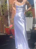 Woman wearing a shiny satin silver dress outdoors near red planters, ZAPDRESS fashion