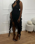 Woman wearing a ruffled black dress and heels, standing indoors at ZAPDRESS