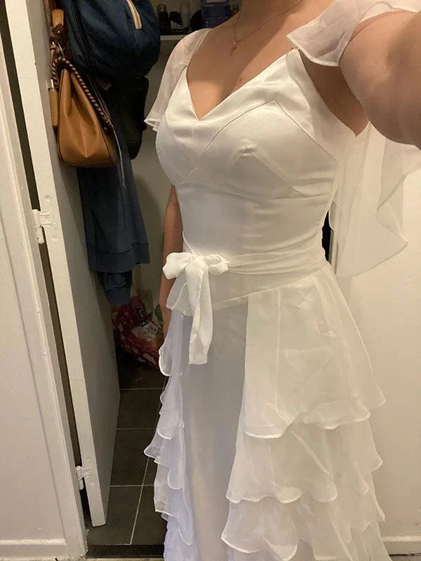 Woman wearing elegant white ruffle dress with waist tie from ZAPDRESS in indoor setting