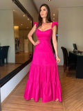 Woman modeling bright pink maxi dress with ruffle sleeves indoors at ZAPDRESS boutique