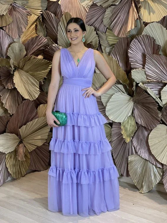 Woman in tiered lavender evening dress holding green clutch, ZAPDRESS fashion backdrop