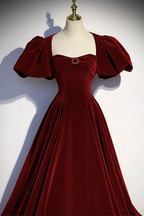 ZAPDRESS burgundy velvet dress with puff sleeves and jeweled accent on mannequin