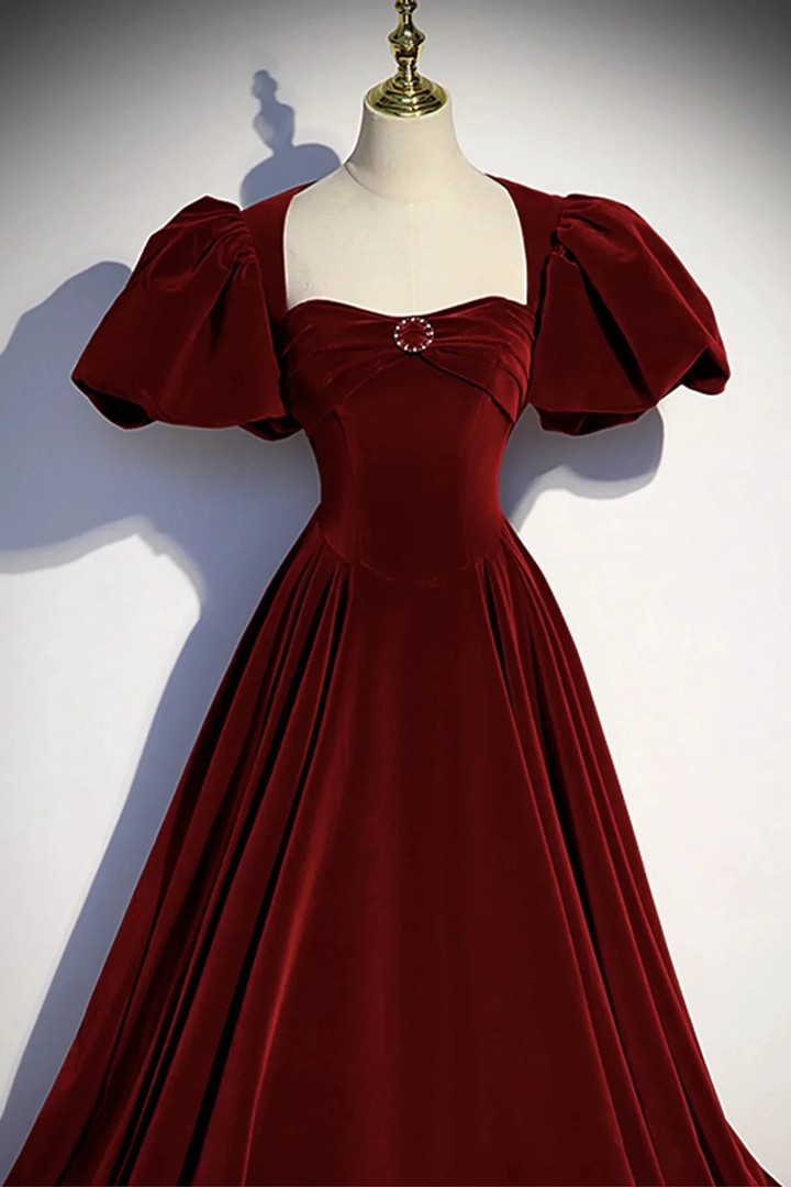 ZAPDRESS burgundy velvet dress with puff sleeves and jeweled accent on mannequin