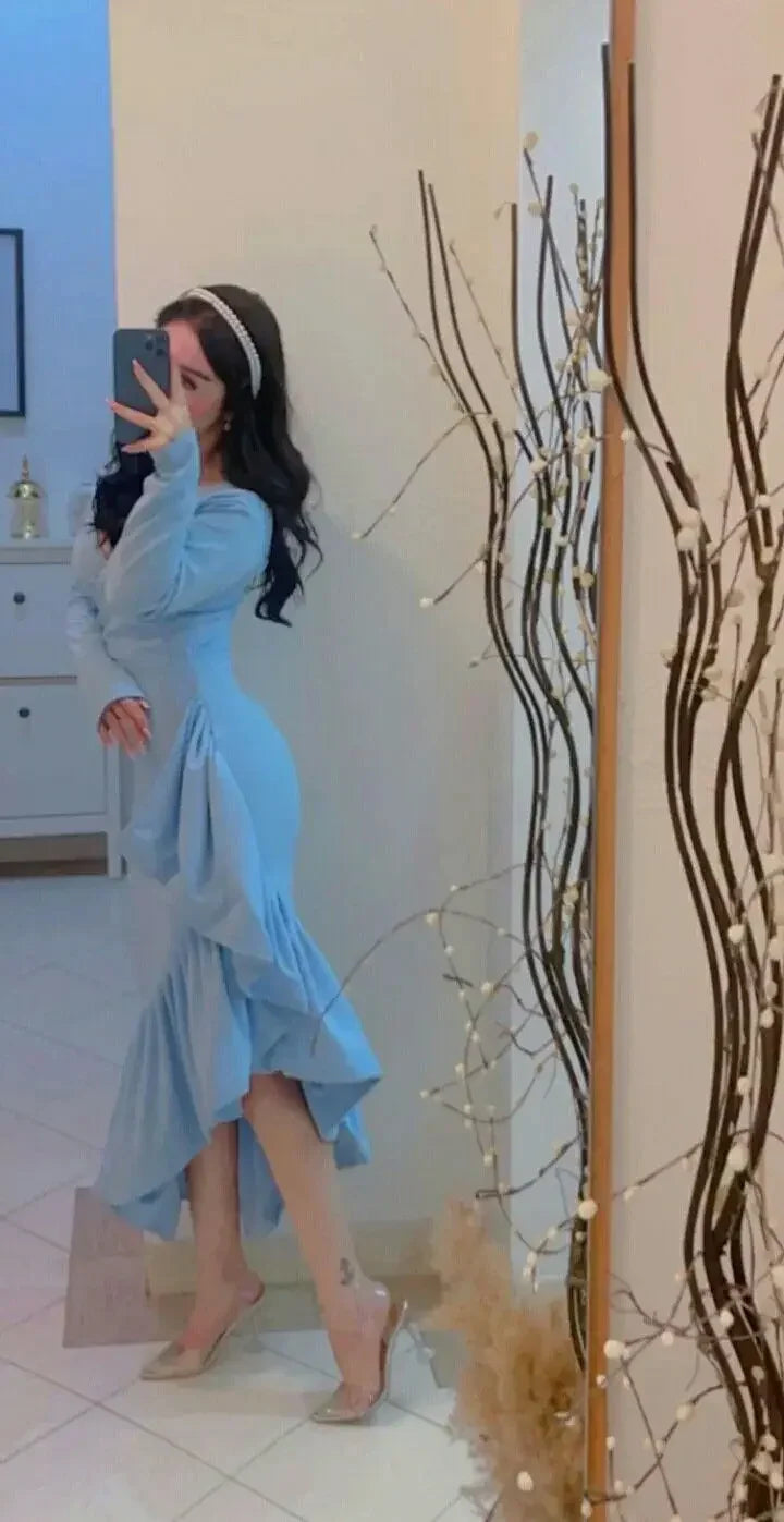 Woman in light blue ruffle dress posing in mirror, ZAPDRESS fashion, elegant home decor