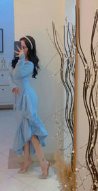 Woman in light blue ruffle dress posing in mirror, ZAPDRESS fashion, elegant home decor