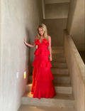 Woman in bright red ruffled dress standing on stairs, ZAPDRESS fashion style