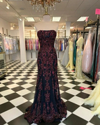 Elegant strapless black and burgundy evening gown on mannequin in ZAPDRESS formal dress store