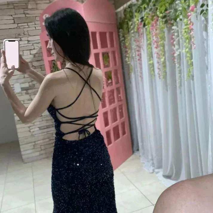 Woman in sequin backless evening dress taking mirror selfie, pink door and floral backdrop, ZAPDRESS