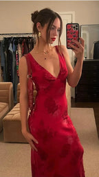 Woman taking a mirror selfie in a red floral dress from ZAPDRESS, boutique dressing room