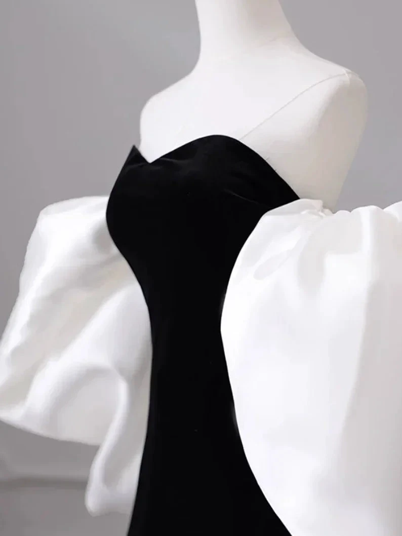 Elegant black dress with dramatic white puff sleeves on mannequin, ZAPDRESS fashion