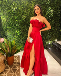 Woman in a red off-shoulder evening dress with high slit, posing indoors by green wall, ZAPDRESS