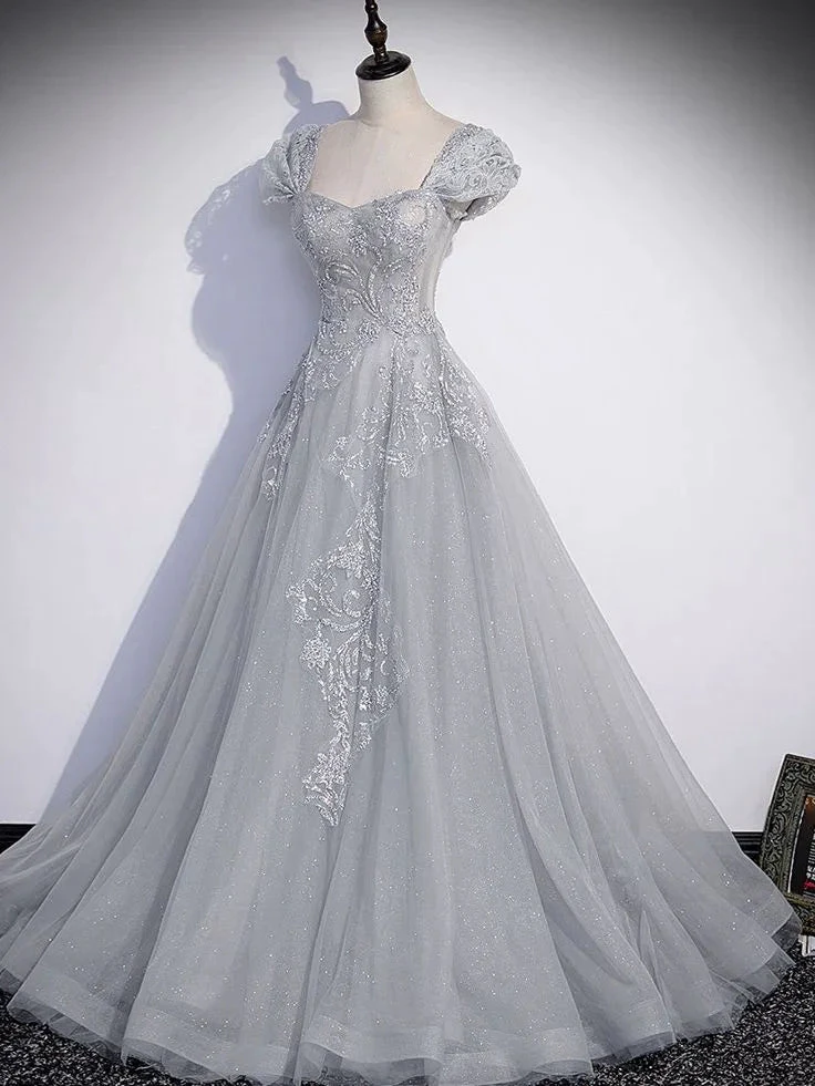 Elegant silver ball gown with lace and glitter detailing on a mannequin, ZAPDRESS fashion
