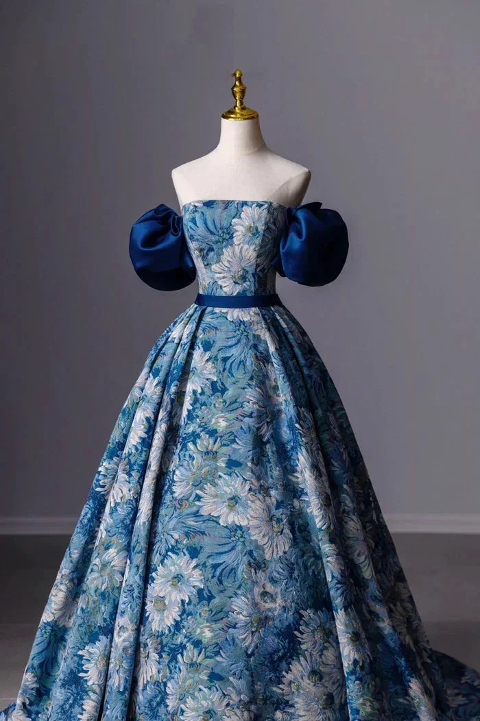 Elegant blue floral ball gown with puff sleeves on mannequin at ZAPDRESS