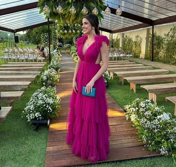 Woman in a vibrant pink evening gown at an outdoor wedding venue, ZAPDRESS fashion style