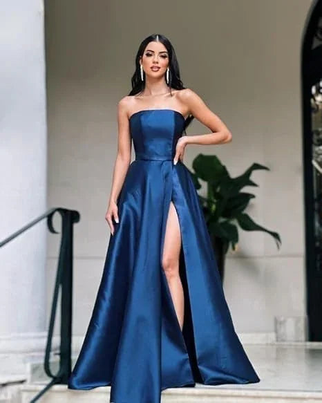 Woman wearing elegant blue strapless evening dress with thigh-high slit, ZAPDRESS fashion
