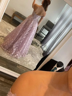 Woman in mirror wearing a strapless mauve lace evening gown at ZAPDRESS boutique