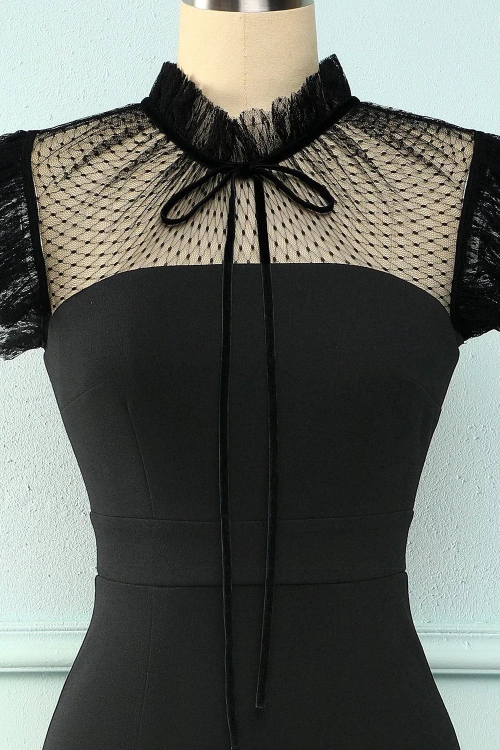 Black dress from ZAPDRESS with lace mesh neckline and bow detail on mannequin