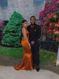 Elegant couple posing outdoors, woman in shiny orange gown, ZAPDRESS fashion style
