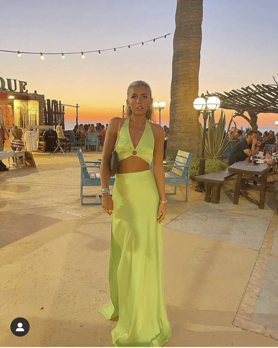 Woman in lime green halter maxi dress at sunset beach bar, ZAPDRESS fashion style