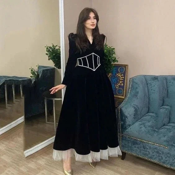 Woman in a long black velvet dress with pearl details at ZAPDRESS boutique