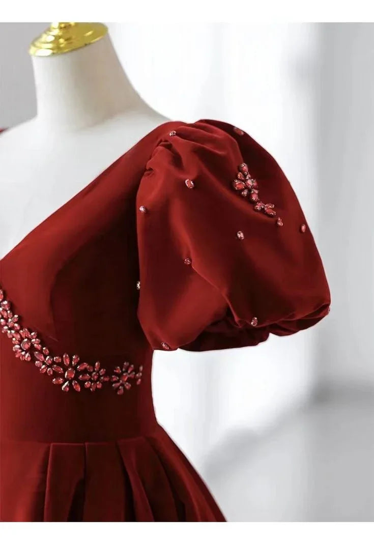 Elegant red dress with puff sleeve and floral embellishments on mannequin, ZAPDRESS fashion