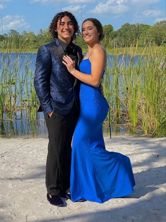 Couple in formal attire by lake, woman in elegant blue evening dress from ZAPDRESS