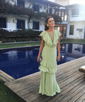 Woman in mint green ruffle dress by a pool, outdoor setting, ZAPDRESS fashion style
