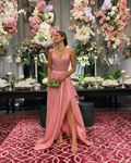 Woman in pink evening gown posing at floral event, elegant decor, ZAPDRESS fashion