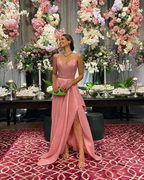 Woman in pink evening gown posing at floral event, elegant decor, ZAPDRESS fashion