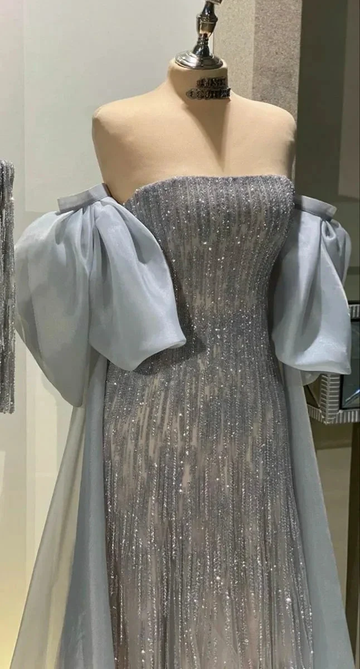 Elegant silver sequin evening gown with sheer puff sleeves on mannequin at ZAPDRESS