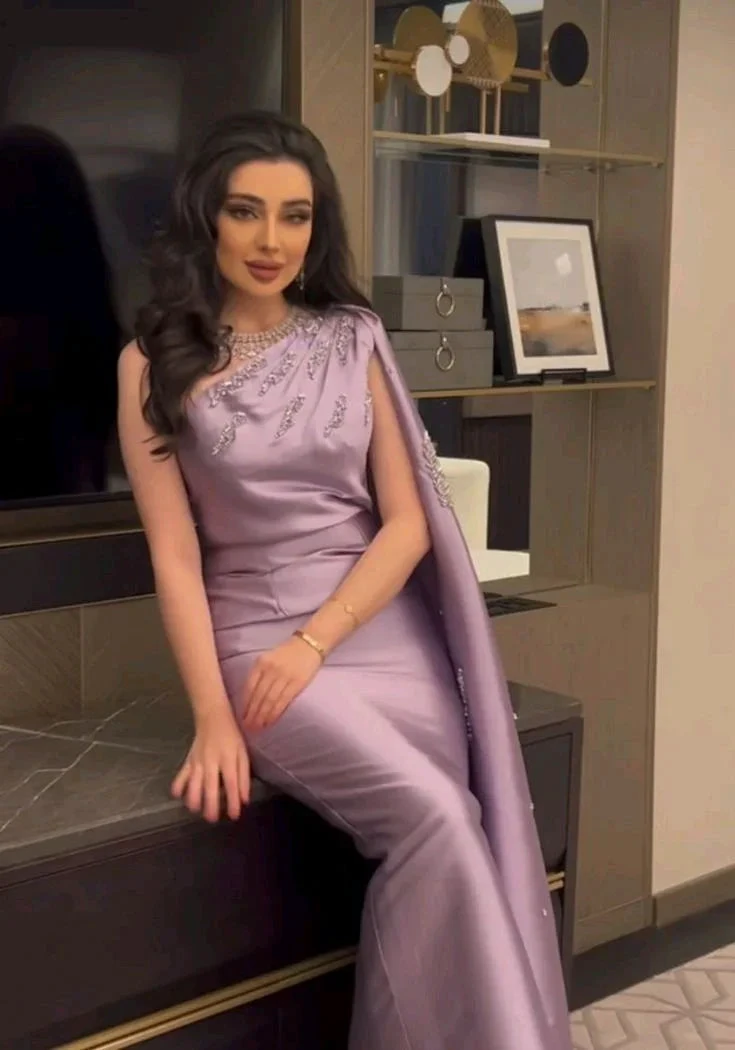 Woman in elegant lavender evening gown with embellishments, seated indoors, ZAPDRESS fashion