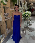 Woman in royal blue strapless gown at elegant event with floral and crystal decor - ZAPDRESS