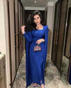 Woman in elegant royal blue dress with cape, holding a stylish handbag, ZAPDRESS fashion