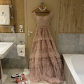 Elegant pink tiered tulle gown with pearls and matching heels in luxe bathroom, ZAPDRESS