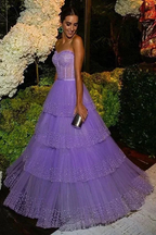 Woman in a tiered lavender tulle evening gown at a floral outdoor event, ZAPDRESS fashion