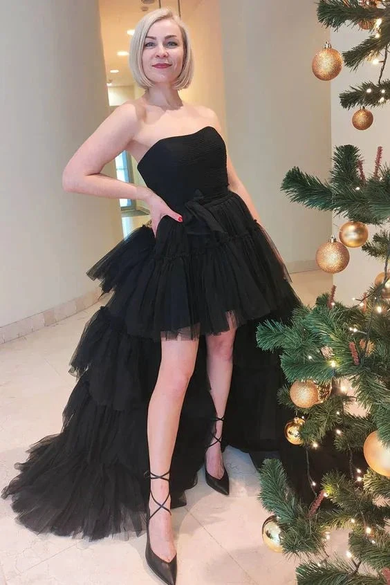 Woman in a strapless black tulle evening dress near a decorated Christmas tree, ZAPDRESS