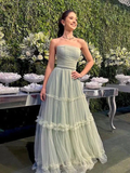 Woman in strapless light green gown posing at elegant event, ZAPDRESS formal dress