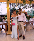 Stylish couple posing outdoors, woman in elegant off-shoulder dress, man in white shirt, ZAPDRESS fashion