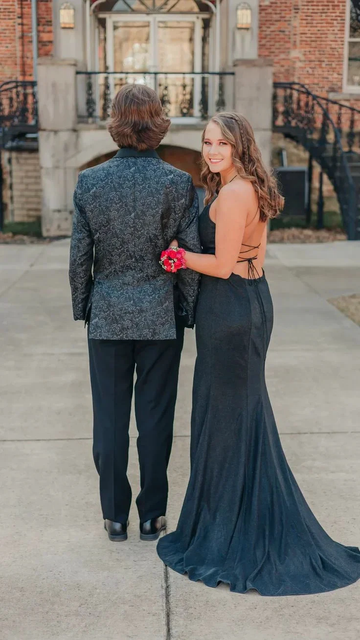 Couple in formal attire, woman in elegant backless gown, outdoor walkway, ZAPDRESS style