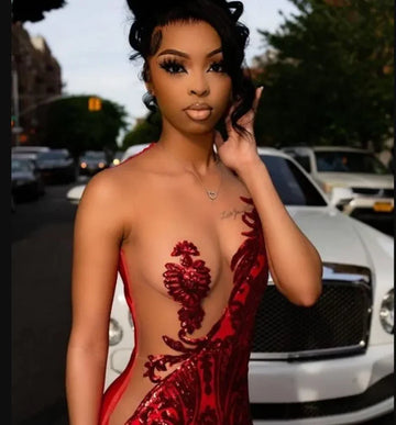 Woman in elegant red velvet evening gown posing outdoors with white luxury car, ZAPDRESS fashion