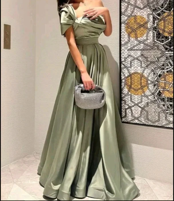 Elegant woman in satin sage green evening gown with silver clutch, ZAPDRESS fashion style