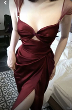 Woman wearing a deep red satin evening dress with a high slit from ZAPDRESS
