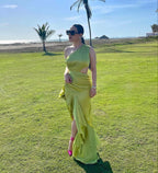 Woman in lime green one-shoulder gown with ruffles, sunglasses, outdoors near beach, ZAPDRESS