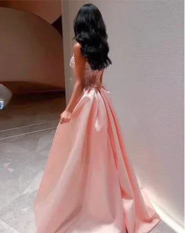 Woman in elegant light pink evening gown with flowing skirt, ZAPDRESS formal dress fashion